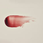 Manuka Health Eternal Renewal Nourishing Lip Balm swatch on a beige background