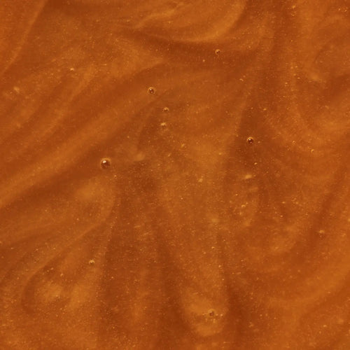 Close-up of a brown, textured surface of Manuka Health Manuka Honey Reserve MGO 1000+.