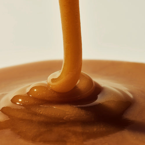 Manuka Health Manuka Honey Ultra MGO 800+ being drizzled into a bowl.