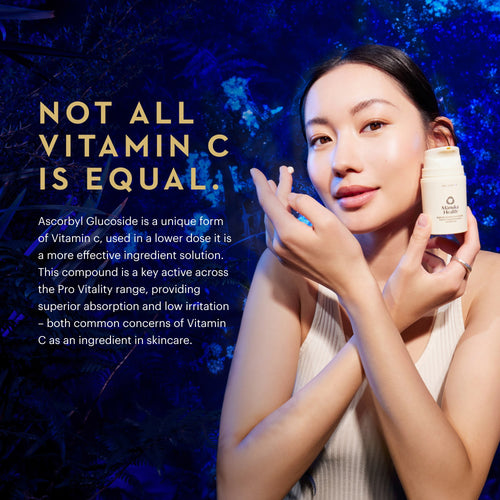A woman holds a small white skincare bottle against a dark blue textured background, with large gold and white text on the left reading 'NOT ALL VITAMIN C IS EQUAL.' and descriptive copy about Ascorbyl Gluconide.