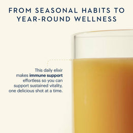 Glass of orange juice elixir with text about immune support and year-round wellness.
